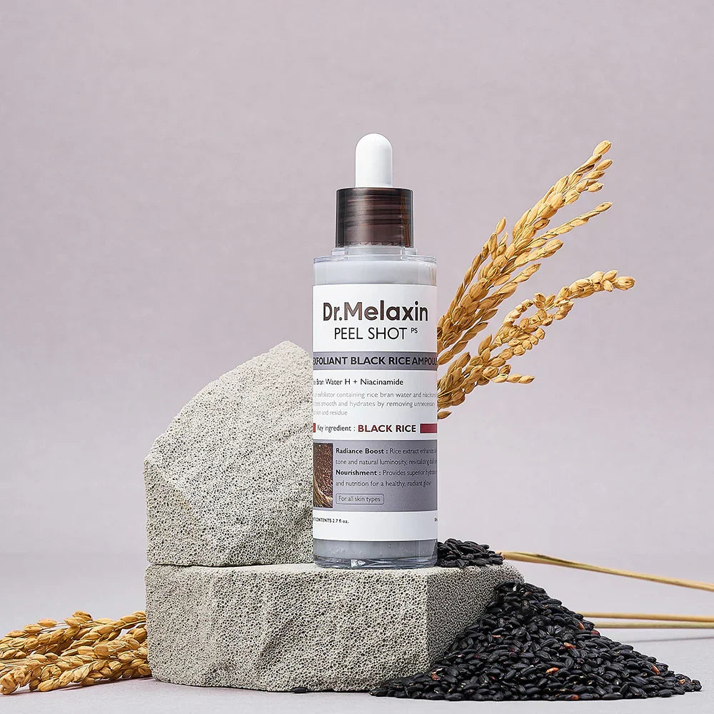 Dr. Melaxin peel shot bottle with black rice and grains on a stone block against a gray background
