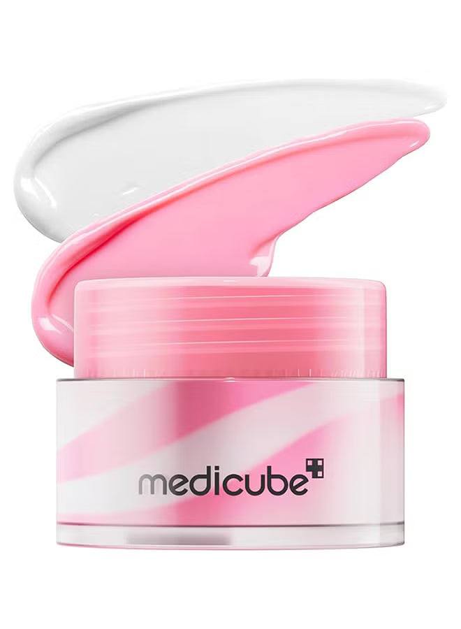 A pink cosmetic cream jar with the lid open, showing a thick swipe of white cream above. The jar has pink and white diagonal stripes and the brand name 'medicube' printed on the front, set against a plain white background.
