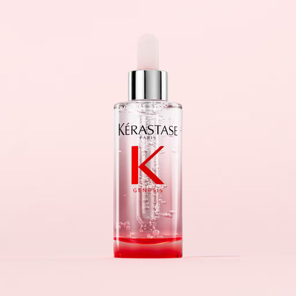 Kerastase bottle on a pink background