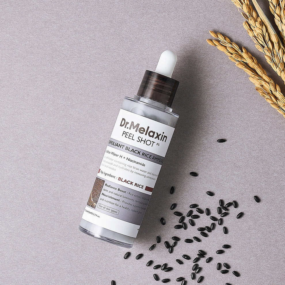 Dr. Melaxin peel shot bottle with black rice seeds on a gray background
