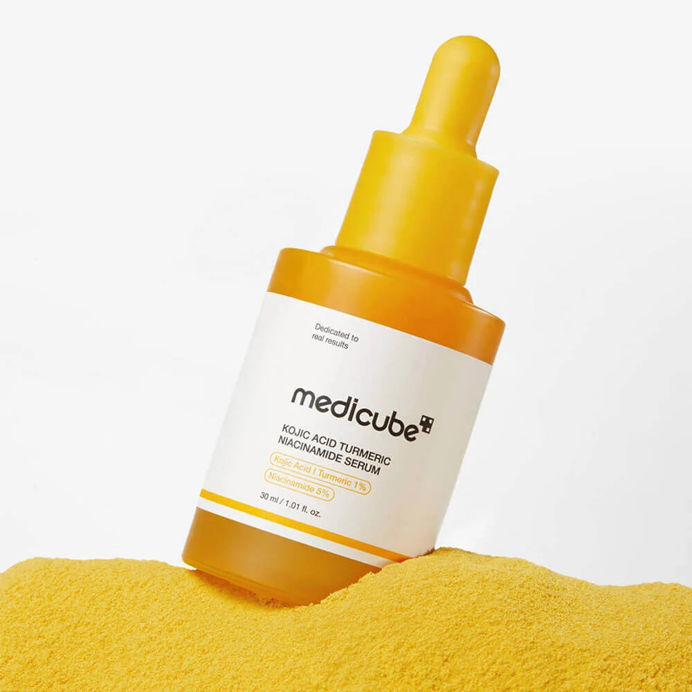 Medicube serum bottle with yellow dropper on a white background