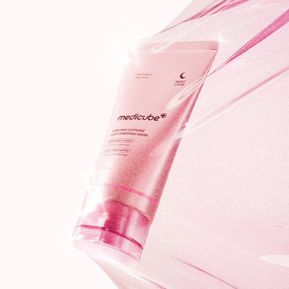 A pink Medicube hair care tube wrapped in a translucent pink sleeve, photographed on a bright white background with soft light reflections.