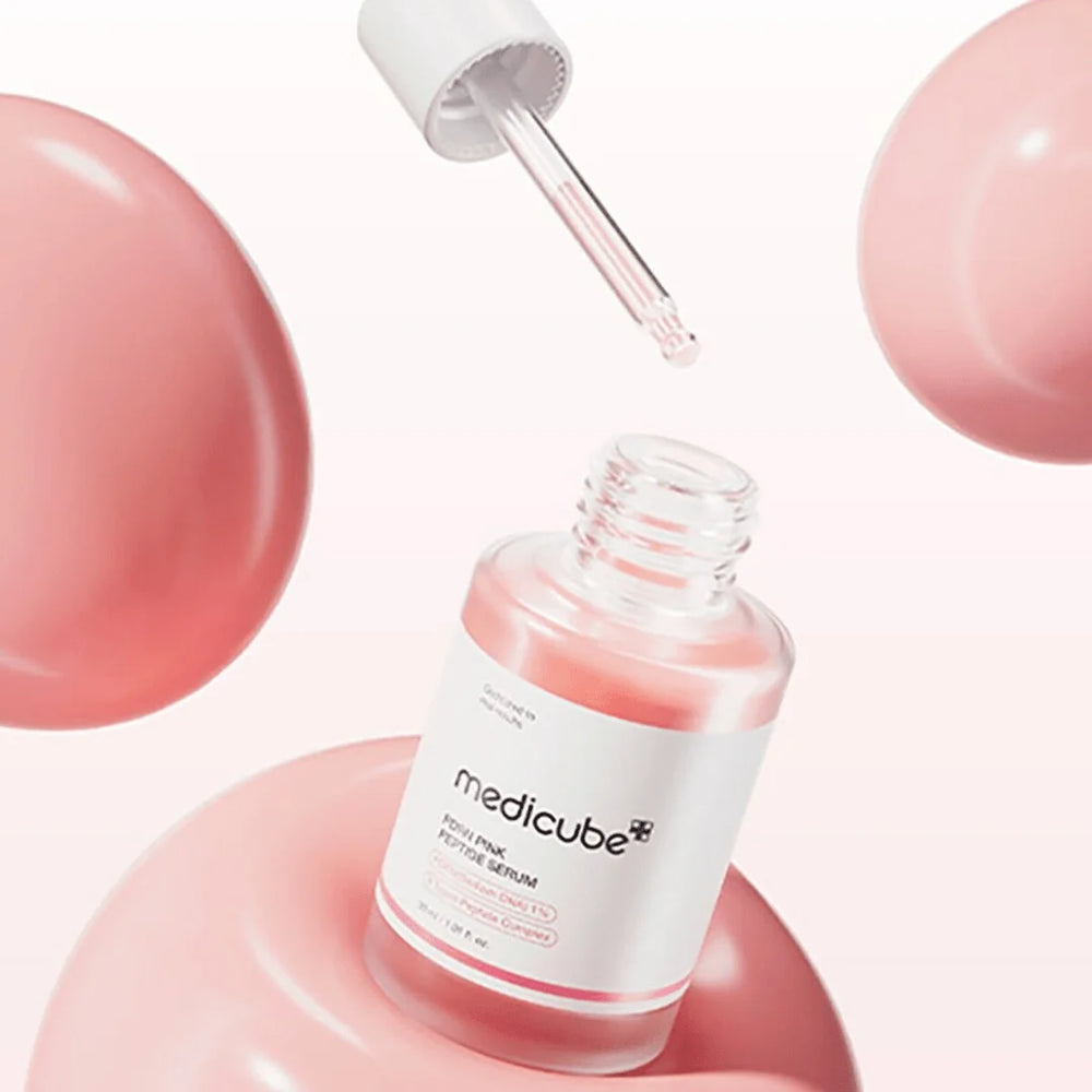 Skincare product with dropper and 'Medicube' branding on a pink background