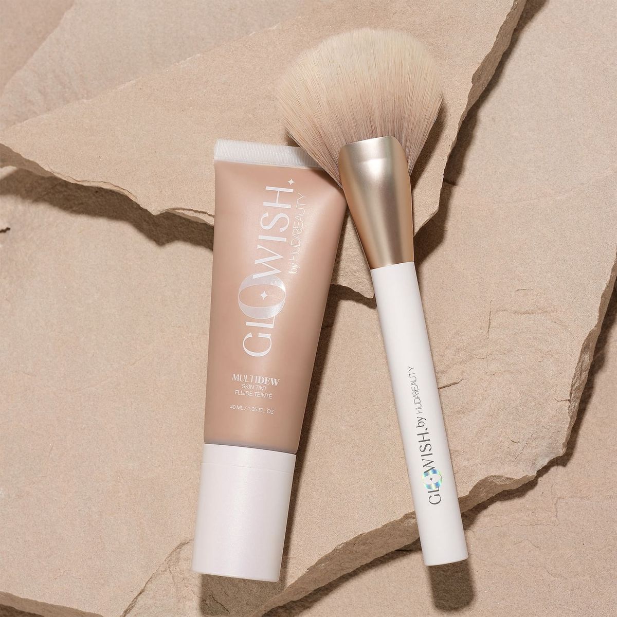 GloWish by Huda Beauty MultiDew Vegan Skin Tint Foundation squeeze tube in Shade 05 Medium against a light background.